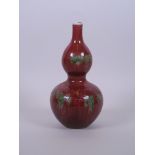 A Chinese double gourd porcelain vase with slender neck and flambé glaze, 8" high