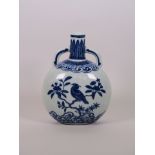 A small Chinese blue and white porcelain flask with twin handles and bird decoration, four character