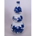 A Chinese blue and white porcelain triple gourd vase decorated with kylin and clouds, blue seal mark