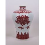 A Chinese red and white porcelain baluster shaped vase decorated with peaches, pomegranate and