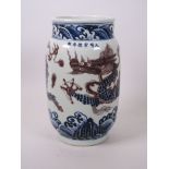 A Chinese blue and white porcelain cylinder vase decorated with a dragon chasing the flaming