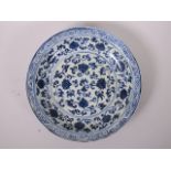 A Chinese blue and white porcelain dish with scrolling lotus flower decoration, 11½" diameter