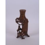 A Chinese coppered bronze spill vase decorated with a sage on horseback, 6" high