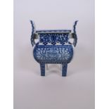 A Chinese two handled porcelain censer on square tapering supports, with foliate decoration, 8" high