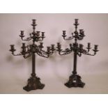 An imposing pair of bronze nine branch candelabra, arranged in two tiers, with classical