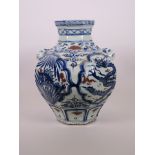 A Chinese octagonal blue and white pottery jar with mask handles and decorative panels with red