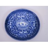 An Oriental blue and white oval platter decorated with hawthorn blossom and a central panel of a