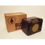 A Bush DAC 90A wireless receiver, In mottled brown Bakelite case, all-yellow dial, within the