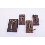 Four early 20th century Morse keys, Unmarked, one with ebonite panel in mahogany base; and three