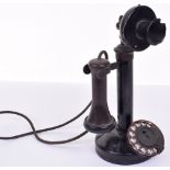 A GEC black candlestick telephone, 1920s, with ebonite receiver, C-type microphone and brass dial;