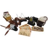 A collection of handheld stereo-viewers and cards: An Underwood & Underwood metal hooded viewer; a