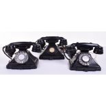 Three pre and post-war 200-series black Bakelite telephones: 1936, with dial and drawer; 1946 with