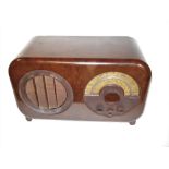 A good Ekco type AC85 wireless receiver, Period speaker cloth and arc dial, in mottled brown