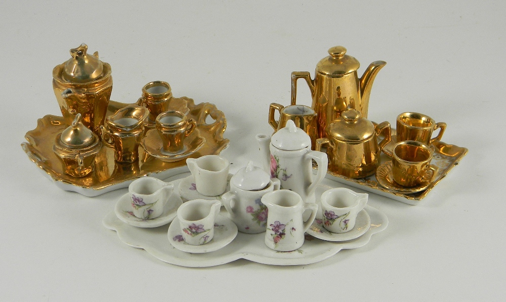 Three miniature tea/coffee services on trays, German circa 1910