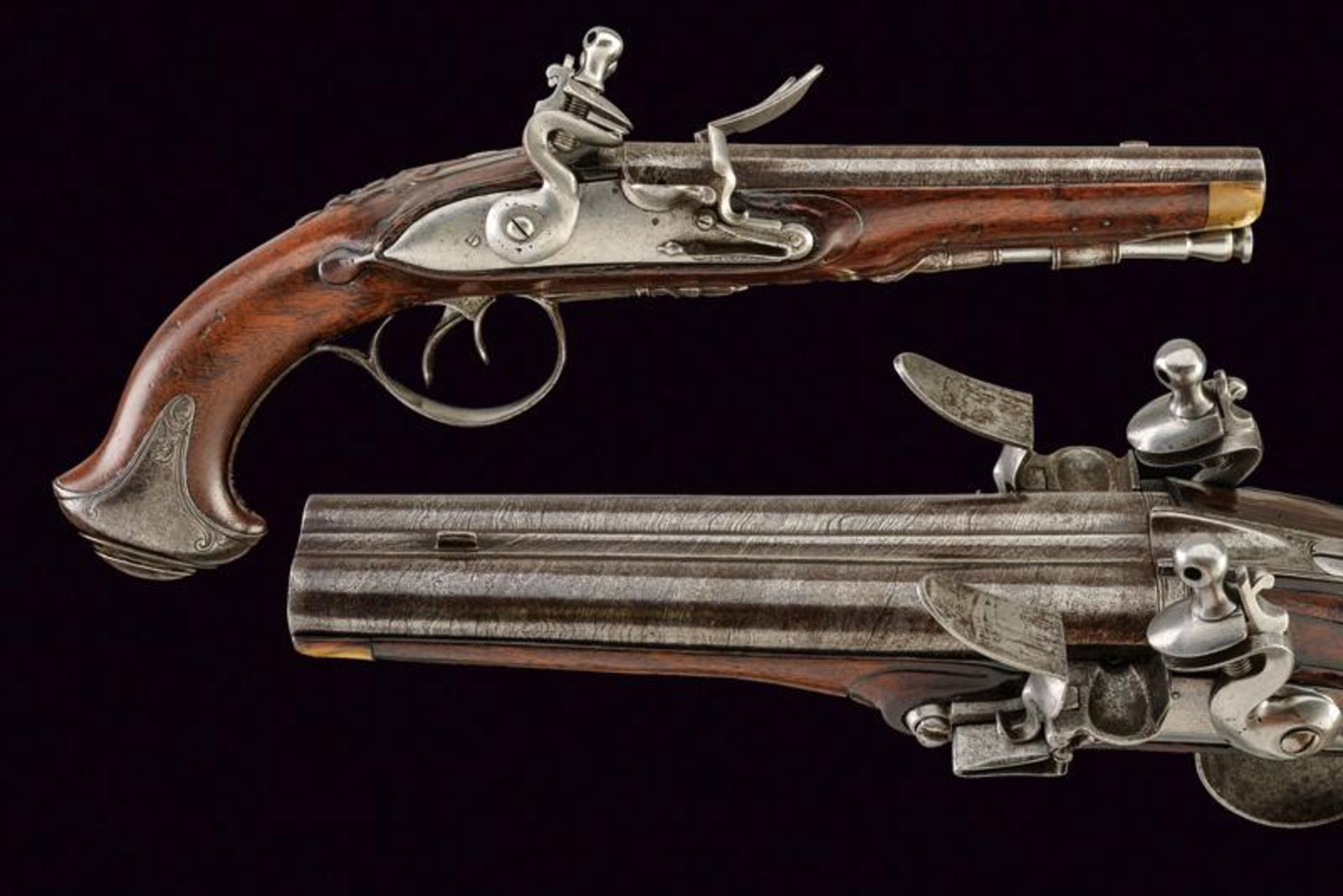 A double barrelled flintlock pistol