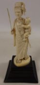 19th century Indian Ivory carved model of a female holding a baby & sword on ebonised plinth H15cm
