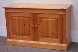Polished pine cupboard, panelled doors, W127cm, H78cm,
