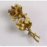 Gold rose bud brooch set with a ruby stamped 18k approx 10.