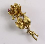 Gold rose bud brooch set with a ruby stamped 18k approx 10.