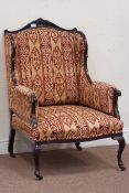 Late Victorian mahogany framed upholstered wing back armchair on angular cabriole legs
