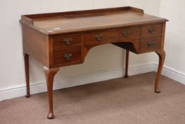 Early 20th century walnut kneehole dressing/writing table, five drawers, W130cm, H81cm,