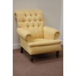 Victorian style armchair upholstered in pale yellow fabric,