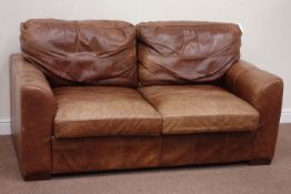 Two seat sofa upholstered in tan leather,