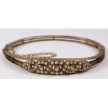 Edwardian gold hinged bangle set with diamonds and seed pearls tested to 14K approx 14gm