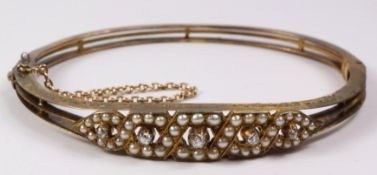 Edwardian gold hinged bangle set with diamonds and seed pearls tested to 14K approx 14gm