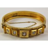 Etruscan revival hinged gold bangle set with central diamond of approx 0.