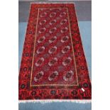 Persian red ground Bokhara rug, 326cm x 166cm Condition Report <a href='//www.