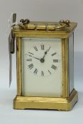 Brass carriage timepiece with white enamel dial,