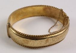 Gold hinged bangle, rope twist border and scroll decoration hallmarked 9ct approx 29.