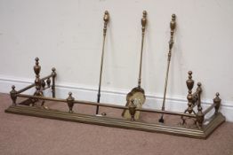 Brass fender, W135cm, four tool companion set and pair of cast fire dogs,