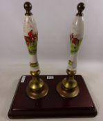 Pair of beer hand pumps decorated with hunting scenes,