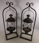 Pair of wrought metal hanging lanterns with stand,