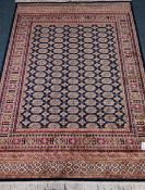 Persian Bokhara style blue ground rug,