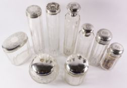 Collection of nine Victorian and later dressing table jars with hallmarked silver tops (one