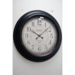 Large circular wall clock in black metal frame,