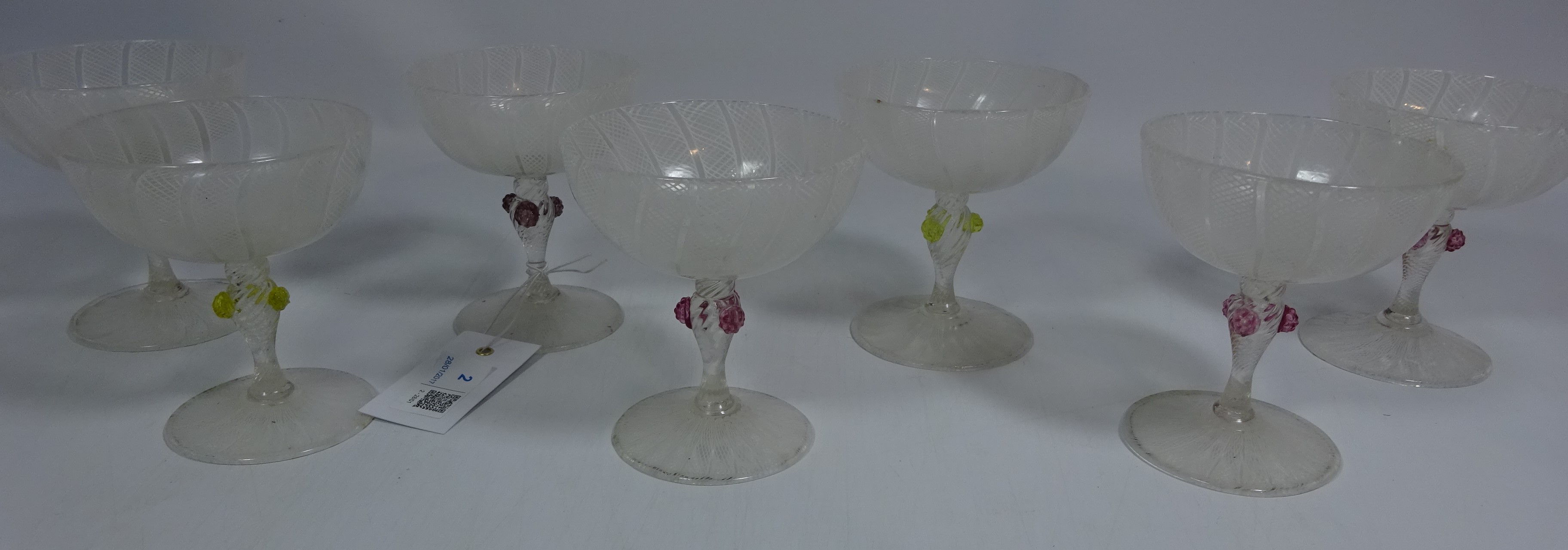 Seven 19th Century Venetian champagne glasses with latticino decoration and stems with coloured