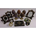 Three enamelled metal easel picture frames, five similar musical eggs, other picture frames,