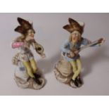 Pair of early 20th Century continental porcelain candle holders in the form of musical figures (2)