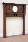 Early 20th century oak fire surround, circular bevelled mirror, carved mounts, W136cm, H159cm.