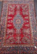 Persian rug, blue pole medallion on red field, featuring repeating boteh motif,