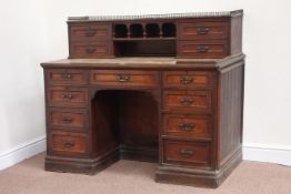 Edwardian oak knee hole desk, nine drawers, with a further four raised drawers, brass gallery,