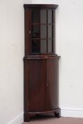 Reproduction mahogany bow front corner cabinet, astragal glazed door above cupboard,
