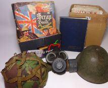 Two military helmets, gas mask, war magazines,