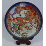19th Century Japanese charger decorated in brick red with figures and animals with six figure