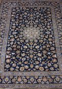 Persian Kashan rug, central rosette medallion, blue field covered in floral decoration,