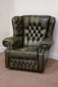 Saxon traditional wingback armchair upholstered in green studded leather,